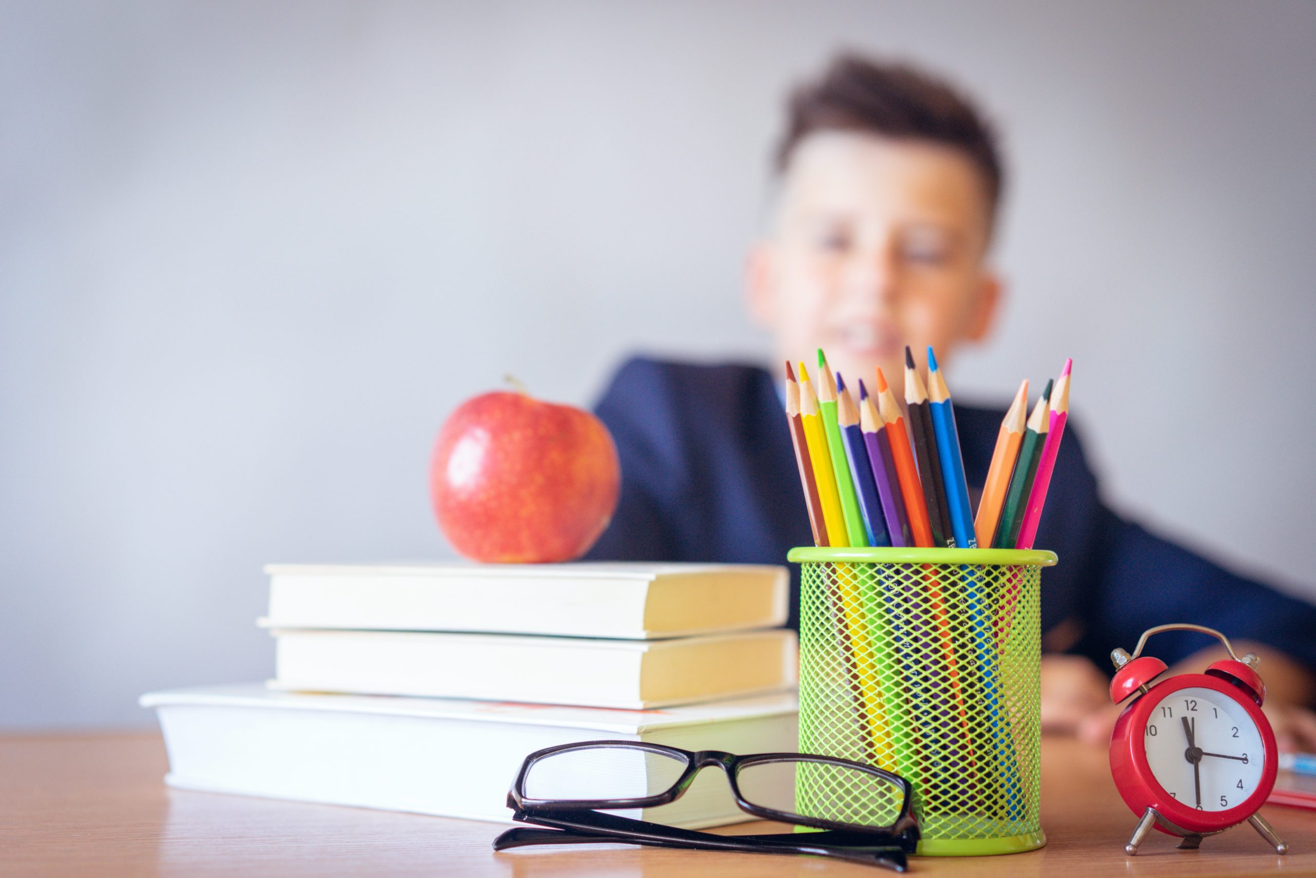 colored pencils in can with child in background